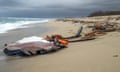 The remains of a shipwrecked boat on a beach.