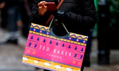 A woman carries a Ted Baker bag