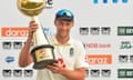 Joe Root, the England captain, holds the trophy.