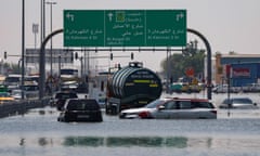 Cars are stranded in flood water on a blocked highway