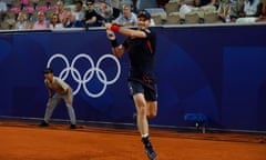 Andy Murray hits a backhand in front of the Olympic rings.
