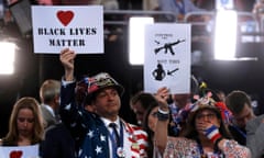 Delegates hold up signs during the second day at the Democratic national convention in Philadelphia, 26 July.