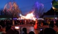 People watch a fire breather in Qinglonghu Park, Beijing, as part of the lunar new year spring festival programme.