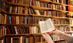 Person holding a book in a library in Salford.