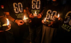 Activists hold candles during a gathering to mark the Earth Hour environmental campaign in Surabaya, Indonesia.