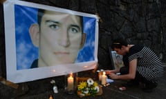 A woman lights a candle in a shrine for Reza Barati during a vigil in support of asylum seekers in Brisbane, Sunday, Feb. 23, 2014. The nation wide vigil was held in response to the death of 23-year-old Iranian man Reza Barati who died while in a detention centre on Manus Island on February 18. (AAP Image/Dan Peled) NO ARCHIVING ozstock