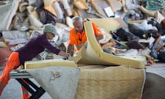 Two Polish workers dismantle a mattress at the ‘DRZ Darmstaedter Recycling Zentrum GmbH’ on June 17, 2015 in Darmstadt, Germany. In the recycling center specific waste such as bulky waste, plastic and polystyrene, metals, paper and construction waste are delivered by households and companies, separated and pressed for further recycling.