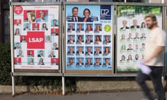 A man passes in front of an election poster in Luxembourg, on Sunday. Conservative opposition party, the CSV, took the largest share of the vote in Sunday’s general election.
