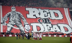 Standard Liege fans display a banner featuring an illustration depicting the decapitation of Anderlecht midfielder Steven Defour