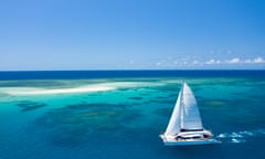 A sailboat tours the outer Great Barrier Reef