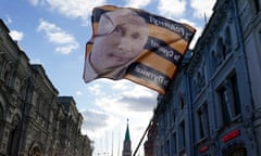 Vladimir Putin’s image is flown on a flag outside the Kremlin in Moscow before this week’s presidential election.