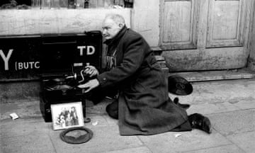 Mr William East cranks his gramophone handle as he begs on the streets of London in May 1969.