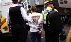 Film-maker Rich Felgate is detained by police officers at a Just Stop Oil protest in London on 15 October.