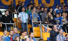 Shrewsbury Town supporters watch a game from the safe standing area at the club’s ground.