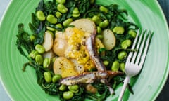 Broad bean, new potato and dandelion salad on a green plate