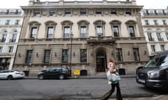 Woman walking in front of Garrick club building