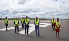 airline bosses and staff standing on a closed runway at heathrow airport