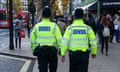 Two Met police officers patrol Oxford Street, London, at Christmas time