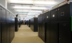 Looking down a walkway in an office flanked by filing cabinets