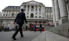 Commuters walk past the Bank of England in London