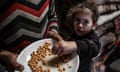 Palestinian children try to eat from a single bowl inside the tent as Palestinians, trying to live in makeshift tents they set up, are viewed in Rafah, Gaza on February 14, 2024. Palestinians who fled from Israeli attacks and sought refuge in Rafah city, located in the southern Gaza Strip, are facing immense challenges in their struggle for survival. The overcrowded conditions in the city have forced some families to reside in tents, and despite the cold weather, many displaced Palestinians are grappling with a shortage of beds and blankets. The dire situation underscores the urgent need for assistance and support in ensuring the well-being of these vulnerable populations. (Photo by Abed Zagout/Anadolu via Getty Images)