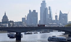 View of the City of London financial district with a bridge crossing the Thames in foreground