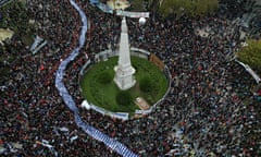 aerial picture of lots of people in a square with a long blue banner