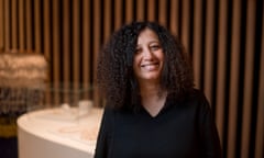 A middle-aged Maghrebian woman smiling at the camera