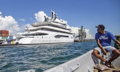 FILE - Boat captain Emosi Dawai looks at the superyacht Amadea where it is docked at the Queens Wharf in Lautoka, Fiji, on April 13, 2022. On May 5, five U.S. federal agents boarded the massive Russian-owned superyacht Amadea that was berthed in Lautoka harbor in Fiji in a case that is highlighting the thorny legal ground the U.S. is finding itself on as it tries to seize assets of Russian oligarchs around the world. (Leon Lord/Fiji Sun via AP, File)