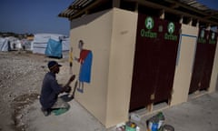 Haiti Recovery<br>PORT-AU-PRINCE, HAITI - FEBRUARY 2011:  Oxfam sanitation project in one of the tent camps. They hire local artists to hand paint their logo, and paint images that can be used for education, February, 2011 in Port-au-Prince, Haiti.  (Photo by Jonathan Torgovnik/Getty Images)