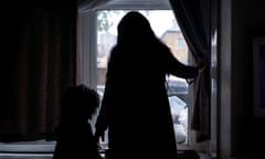 Silhouette of a mother and daughter looking out of a window