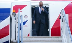 James Cleverly steps out of the doorway of a BA plane to walk down aircraft steps