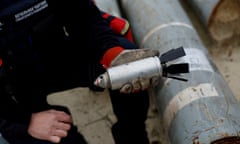 A Ukrainian serviceman holds a defused cluster bomb from an unexploded Russian missile in Kharkiv, Ukraine, on 21 October 2022.