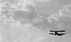 a 1920s biplane in flight.