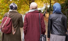 British Muslim Female Friends Walking In Urban Environment