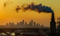 An oil refinery spews pollution with the city of Houston, Texas, in the background.