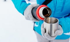 Woman pouring hot drink from a flask