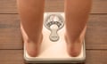 Woman standing on weighing scales