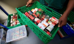 A worker holds a food parcel