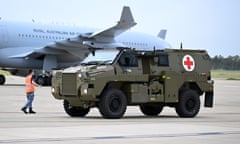 An Australian Bushmaster PMV Armoured Vehicle is loaded onto a RAAF C-17 cargo plane at the Amberley Air Base in Ipswich Australia