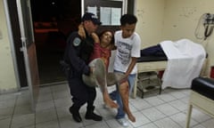 In this March 11, 2012 photo, a woman who was injured during a shooting at a pool hall gets emergency medical attention from doctors and nurses at the Catalino Rivas Public Hospital in San Pedro Sula, Honduras. A wave of violence has made Honduras among the most dangerous places on Earth, with a homicide rate roughly 20 times that of the U.S. rate, according to a 2011 United Nations report. (AP Photo/Esteban Felix)