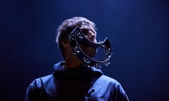 Liam Gallagher with a crescent-shaped tambourine in his mouth