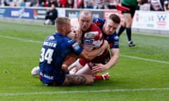 Liam Marshall fights his way over for Wigan’s first try in the play-off semi-final against Hull KR.