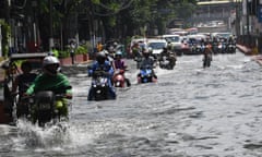 Motorists traverse on a flooded road after heavy downpour brought about by southwest moonson hit Manila on August 14, 2023. (Photo by Ted ALJIBE / AFP) (Photo by TED ALJIBE/AFP via Getty Images)