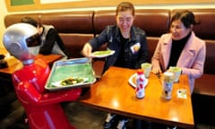 A robot serves customers in a restaurant in Shenyang, China