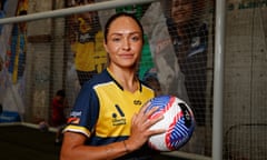 Kyah Simon poses with a football in her Mariners kit in front of a goal at the A-leagues launch event