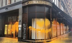 Orange paint is sprayed across the windows of Harrods department store in London