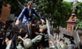 Chavismo elects new president of Parliament without opposition leader Guaido<br>epa08105247 Venezuelan opposition leader Juan Guaido climbs a fence in an attempt to enter the headquarters of the National Assembly, guarded by the police to prevent his entry and that of opposition deputies in Caracas, Venezuela, 05 January 2020. Chavista deputies of the National Assembly (AN, Parliament) elected Luis Parra, former member of the First Justice party, as President of the Parliament, in a brief debate that opposition leader and now former president of the Parliament Juan Guaido did not attend as he was held for hours by the Police around the Legislative Palace. Before the session, troops of the Bolivarian National Police (GNP) and the Bolivarian National Guard (GNB, militarized police), prevented Guaido and other deputies access to Parliament. EPA/Rayner Pena