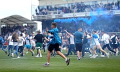 Fans invade the pitch at Bristol Rovers after their incredible 7-0 win against Scunthorpe. 
