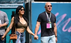 Jeff Bezos and Lauren Sanchez walking hand in hand outdoors